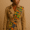 Kente sash over a trench coat
